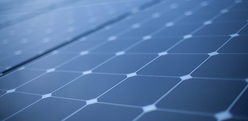 Close-up of blue solar panel cells forming a geometric grid pattern