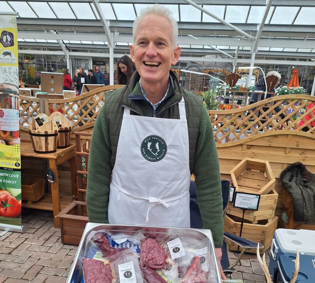 man smiling with meat products