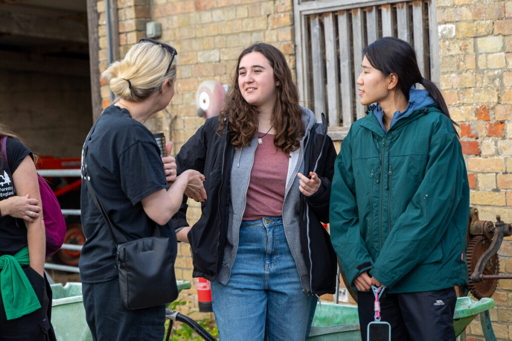 Two Youth board members outside chatting to partner organisation.
