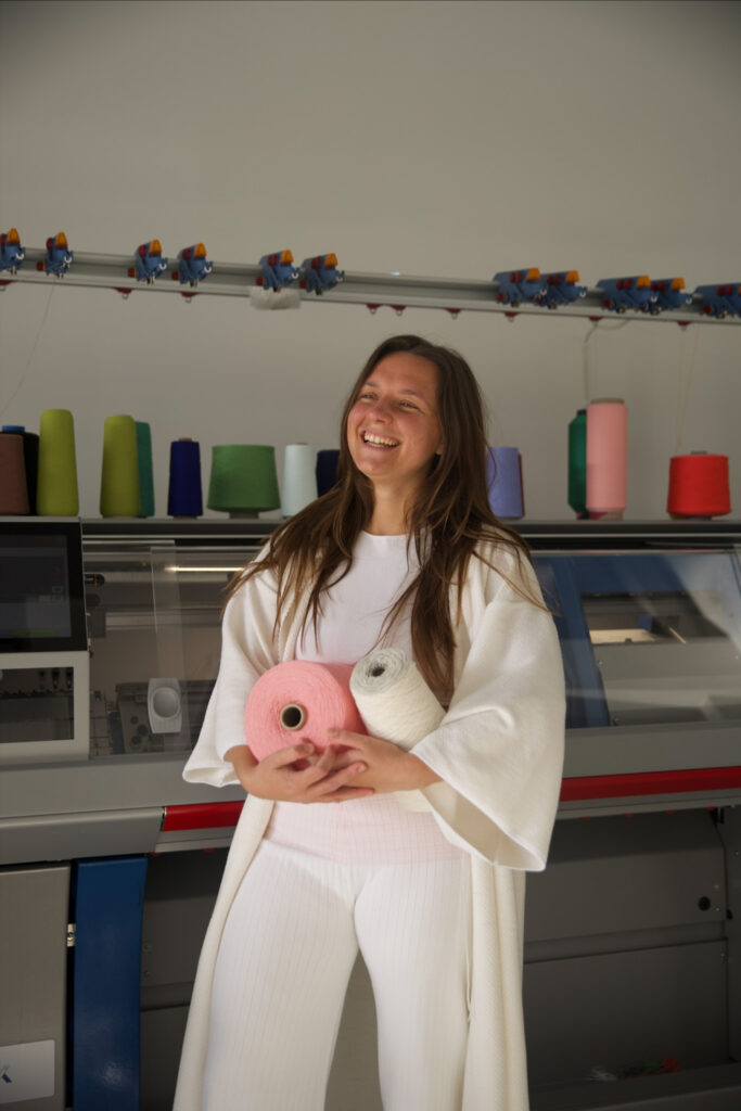 lady holding yarn smiling