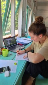 young woman working at desk in remote research station