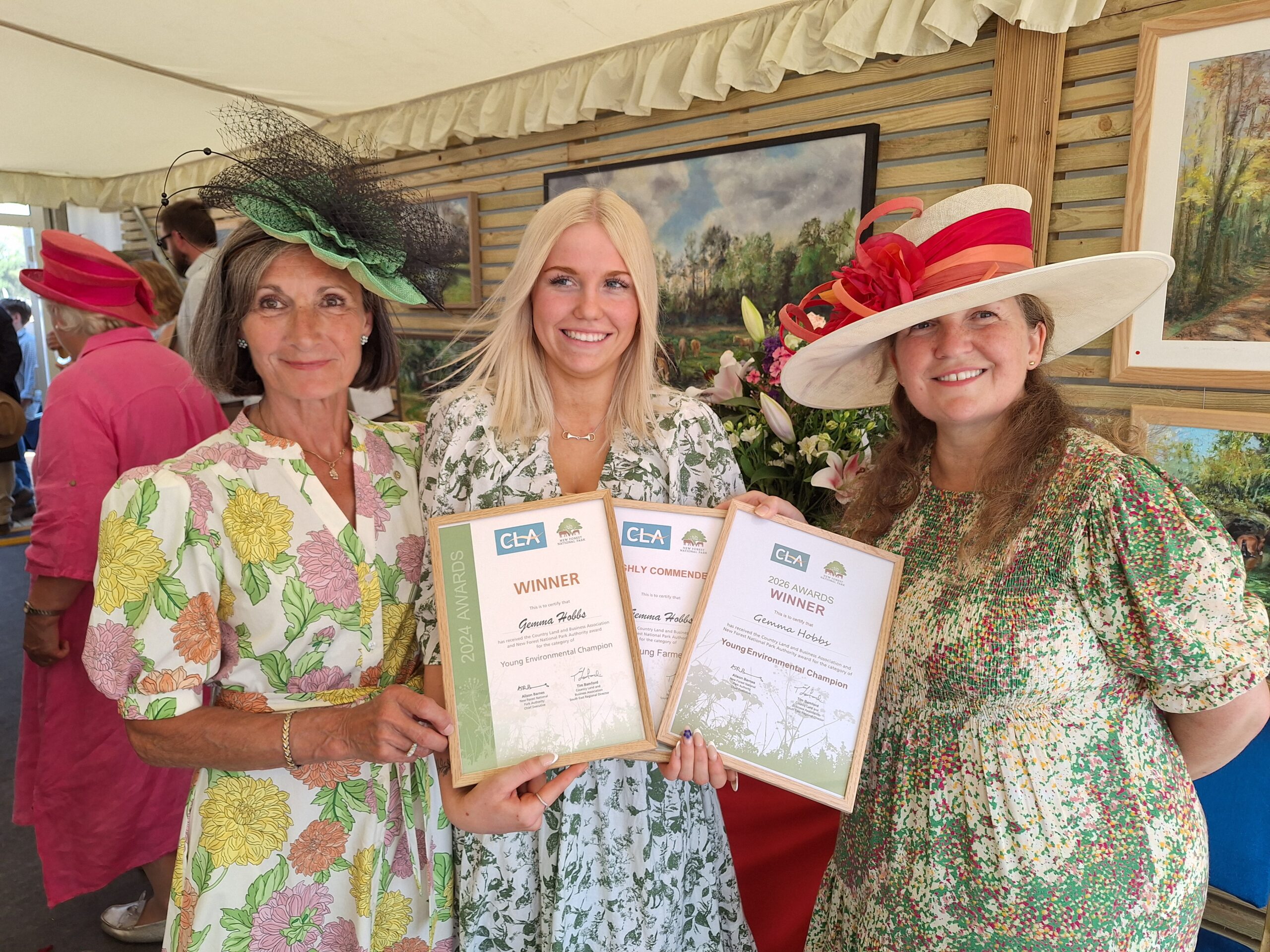 Female standing with awards